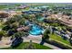 Expansive aerial view of a community featuring multiple pools, tennis courts, and golf course at 36053 N Stoneware Dr, Queen Creek, AZ 85140