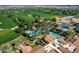 Picturesque aerial view of a resort-style community with golf course, pools, and lush landscaping at 36053 N Stoneware Dr, Queen Creek, AZ 85140