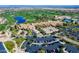 An aerial view of a luxurious community featuring a golf course, clubhouse, parking and lush landscaping at 36053 N Stoneware Dr, Queen Creek, AZ 85140
