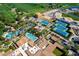 Aerial view of community pools, tennis courts, and golf course offering diverse recreational options at 36053 N Stoneware Dr, Queen Creek, AZ 85140