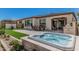 Backyard featuring a hot tub, outdoor dining area, and a covered patio for relaxing and entertaining at 36053 N Stoneware Dr, Queen Creek, AZ 85140