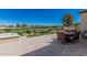 Beautiful backyard with an outdoor dining area overlooking the golf course and mature trees at 36053 N Stoneware Dr, Queen Creek, AZ 85140