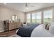 Bedroom boasts bright windows, wood floors, ceiling fan, and golf course views at 36053 N Stoneware Dr, Queen Creek, AZ 85140