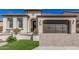 Charming home featuring a brown garage door, landscaped front yard, and inviting entryway with decorative details at 36053 N Stoneware Dr, Queen Creek, AZ 85140