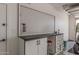Well-lit garage featuring a functional workbench with a pegboard and plenty of storage at 36053 N Stoneware Dr, Queen Creek, AZ 85140