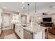 Gourmet kitchen with stainless steel appliances, granite countertops, and island seating at 36053 N Stoneware Dr, Queen Creek, AZ 85140