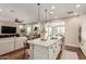 Gourmet kitchen with stainless appliances, granite countertops, island seating and view to outdoor living at 36053 N Stoneware Dr, Queen Creek, AZ 85140