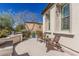 Inviting outdoor patio with stylish seating and a decorative wall feature, perfect for relaxing or entertaining guests at 36053 N Stoneware Dr, Queen Creek, AZ 85140