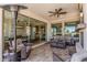 Covered patio with comfortable seating, a ceiling fan, and sliding glass doors to the interior at 36053 N Stoneware Dr, Queen Creek, AZ 85140