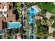 Aerial view of sparkling community pools surrounded by palm trees and well-manicured landscaping at 36053 N Stoneware Dr, Queen Creek, AZ 85140