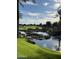 Gorgeous water feature surrounded by lush landscaping and mature trees at 36053 N Stoneware Dr, Queen Creek, AZ 85140