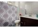 Well-lit bathroom with a decorative shower curtain, modern vanity, and clean fixtures at 3842 E Bartlett Way, Chandler, AZ 85249