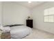 Cozy bedroom with a comfortable bed, neutral color scheme, and a traditional dresser at 3842 E Bartlett Way, Chandler, AZ 85249