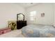 Bright bedroom featuring a patterned quilt, dark wood dresser, and cheerful decor at 3842 E Bartlett Way, Chandler, AZ 85249