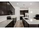 Well-equipped kitchen featuring stainless steel appliances, an island, and dark cabinets at 3842 E Bartlett Way, Chandler, AZ 85249