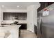 Modern kitchen featuring stainless steel appliances, a spacious island, and dark wood cabinets at 3842 E Bartlett Way, Chandler, AZ 85249