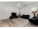 Bright living room with light floors, ceiling fan, and an comfortable leather furniture set at 3842 E Bartlett Way, Chandler, AZ 85249
