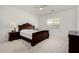 Cozy main bedroom featuring a large bed, carpet, and a window at 3842 E Bartlett Way, Chandler, AZ 85249