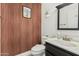 Stylish half bathroom features unique wood-look plank wall and modern fixtures at 3917 E Des Moines St, Mesa, AZ 85205