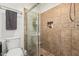 Tiled shower with glass door and built-in shelf in a well-lit bathroom at 3917 E Des Moines St, Mesa, AZ 85205