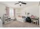 Charming bedroom with a canopy bed, desk, ceiling fan, and neutral colored carpet at 3917 E Des Moines St, Mesa, AZ 85205