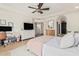 Spacious bedroom with a ceiling fan, home office, and lots of natural light at 3917 E Des Moines St, Mesa, AZ 85205
