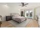 Bright bedroom with a ceiling fan, French doors to the backyard pool, and neutral tones at 3917 E Des Moines St, Mesa, AZ 85205