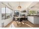 Charming dining area with hardwood floors, large window, and modern light fixture at 3917 E Des Moines St, Mesa, AZ 85205