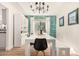 Dining area showcasing a modern table setting, hardwood floors, and a stylish light fixture at 3917 E Des Moines St, Mesa, AZ 85205