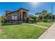 Expansive front yard showcasing a well-maintained lawn, mature palm trees, and inviting curb appeal at 3917 E Des Moines St, Mesa, AZ 85205