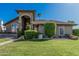 Charming single-story home with a well-manicured lawn and lush landscaping, creating inviting curb appeal at 3917 E Des Moines St, Mesa, AZ 85205