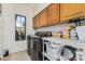 Well-equipped laundry room with cabinetry and a window at 3917 E Des Moines St, Mesa, AZ 85205