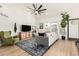 Open concept living area with a modern sectional, green armchair, and stylish decor at 3917 E Des Moines St, Mesa, AZ 85205