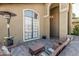 Inviting outdoor patio with comfortable seating, a large window, and elegant columns at 3917 E Des Moines St, Mesa, AZ 85205