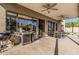 Outdoor patio with a barbecue, ceiling fans, and dining space at 3917 E Des Moines St, Mesa, AZ 85205