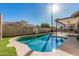 Sparkling backyard pool with a basketball hoop and covered patio at 3917 E Des Moines St, Mesa, AZ 85205
