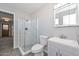 A well-lit bathroom features a glass shower, neutral tile floors, and a modern vanity at 4128 W Las Palmaritas Dr, Phoenix, AZ 85051