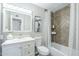 Well-lit bathroom with a modern vanity, herringbone tile accent wall, and bathtub-shower combo at 4128 W Las Palmaritas Dr, Phoenix, AZ 85051