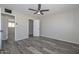 A neutral bedroom features tile floors, a ceiling fan, and ample closet space at 4128 W Las Palmaritas Dr, Phoenix, AZ 85051