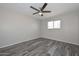 Neutral bedroom featuring tile floors, a ceiling fan, and a view through the window at 4128 W Las Palmaritas Dr, Phoenix, AZ 85051