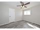Bright bedroom features tile floors, a ceiling fan, a window, and closet at 4128 W Las Palmaritas Dr, Phoenix, AZ 85051