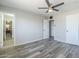 A bright bedroom with tiled floors, a ceiling fan, and multiple doors leading to other rooms at 4128 W Las Palmaritas Dr, Phoenix, AZ 85051
