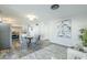 Open-concept dining area featuring modern decor, a round table with gray chairs, and stainless steel appliances at 4128 W Las Palmaritas Dr, Phoenix, AZ 85051