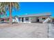 Charming single-story home featuring a white exterior, palm trees, and a covered carport at 4128 W Las Palmaritas Dr, Phoenix, AZ 85051