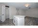Kitchen island overlooks living area, features tile flooring and a neutral palette at 4128 W Las Palmaritas Dr, Phoenix, AZ 85051