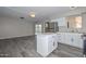 Kitchen features island counter, stainless steel fridge and sink, and ample cabinet space at 4128 W Las Palmaritas Dr, Phoenix, AZ 85051