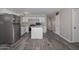 Updated kitchen with stainless steel appliances, white cabinets, and island counter at 4128 W Las Palmaritas Dr, Phoenix, AZ 85051