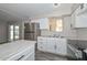 Modern kitchen boasts stainless appliances, white cabinetry, and an island counter at 4128 W Las Palmaritas Dr, Phoenix, AZ 85051
