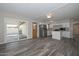 Open floorplan with wood-style tile flooring leading to a sliding door to the patio at 4128 W Las Palmaritas Dr, Phoenix, AZ 85051