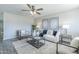 Bright living room with neutral colors, plush seating, ceiling fan, and modern decor at 4128 W Las Palmaritas Dr, Phoenix, AZ 85051